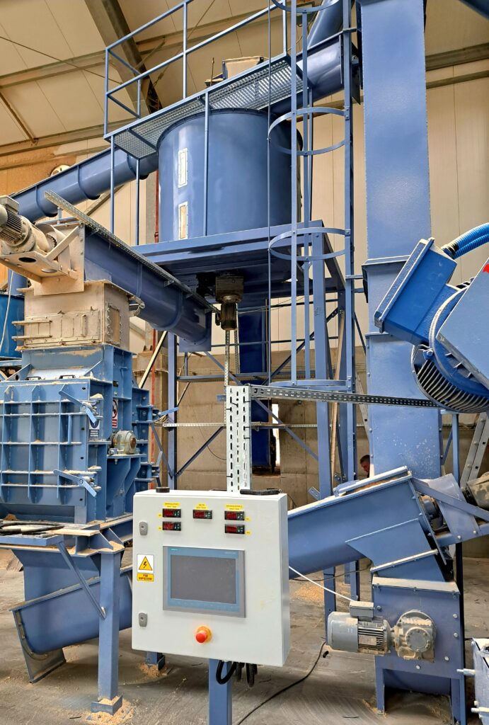 pellet production line, tank with a sawdust mixer above the beater mill, screw feeders for transporting sawdust to and from the